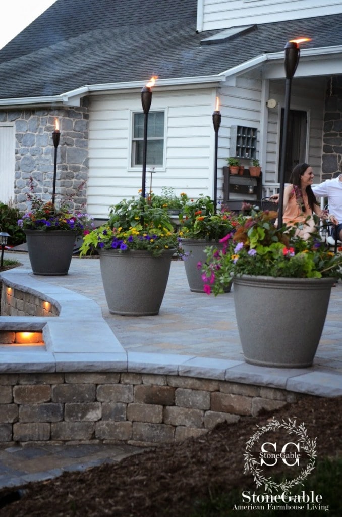 patio with tiki torches in planters