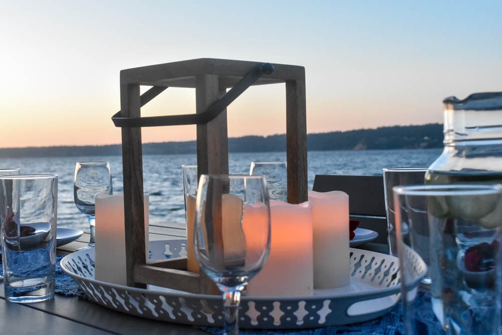 close- up of glowing candle lantern on a 4th of July party table set for Independence day with Puget Sound in the background