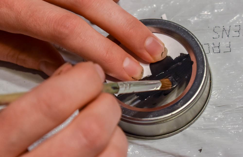 photo of hands painting a spice jar lid