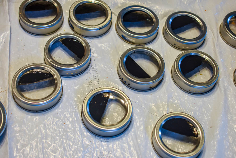 magnetic spice tin lids with black chalkboard paint drying