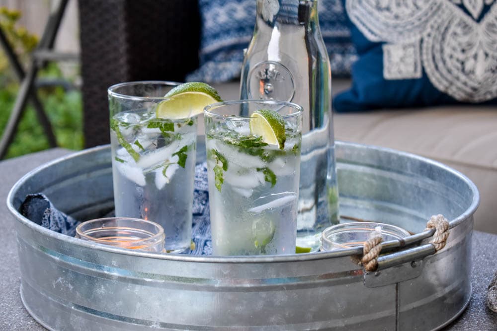 photo of galvanized drink tray with mojitos sitting on a patio coffee table