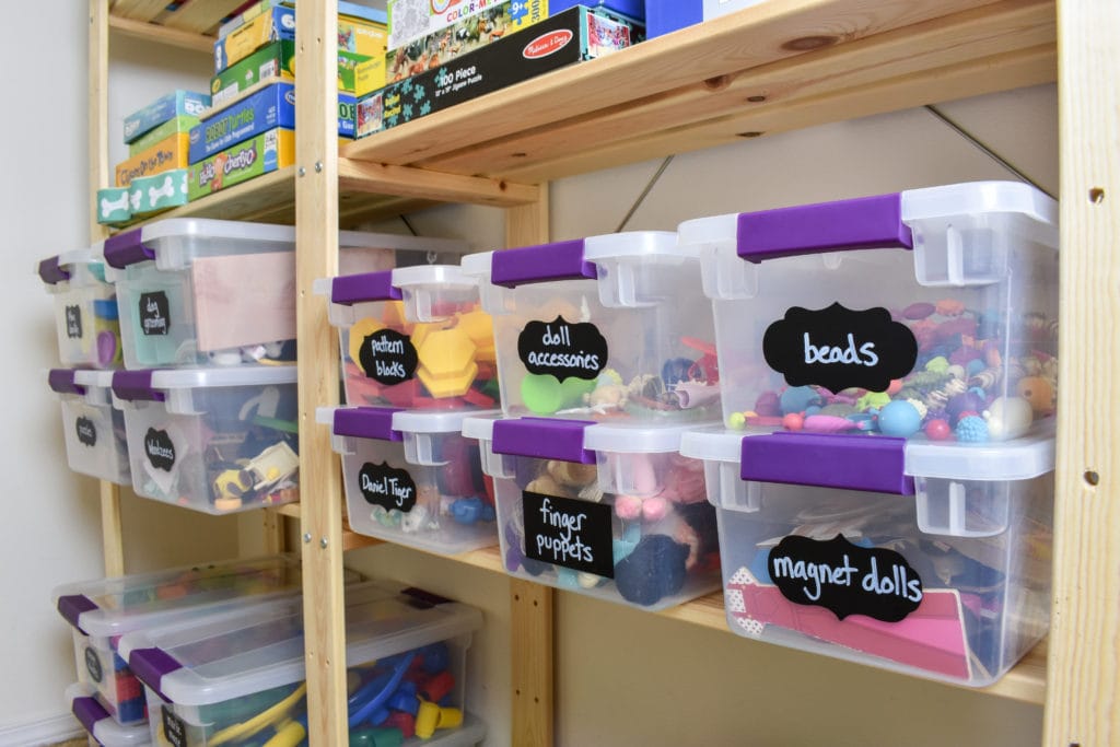 photo of organized toy closet with toy storage bins and wood Ikea shelving