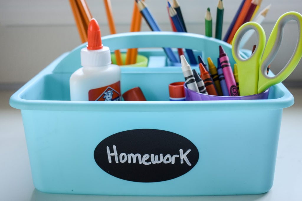photo of homework caddy with crayons, pencils, glue, scissors, and colored pencils 