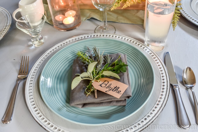 photo of holiday place setting with simple place card holder and fresh herbs