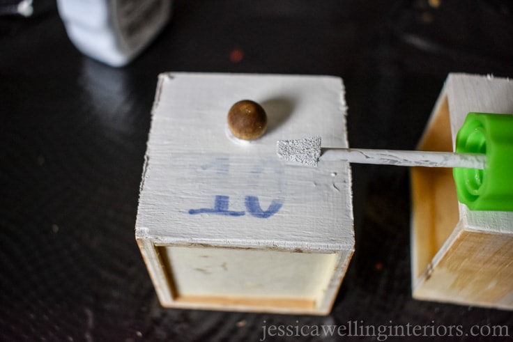 mini drawers from wood advent calendar being painted with white-out