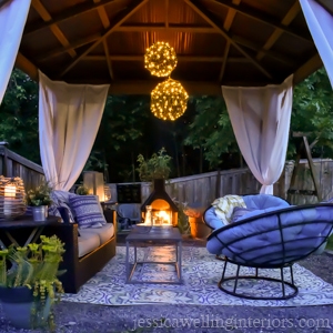 image of outdoor living room with fireplace and chandelier