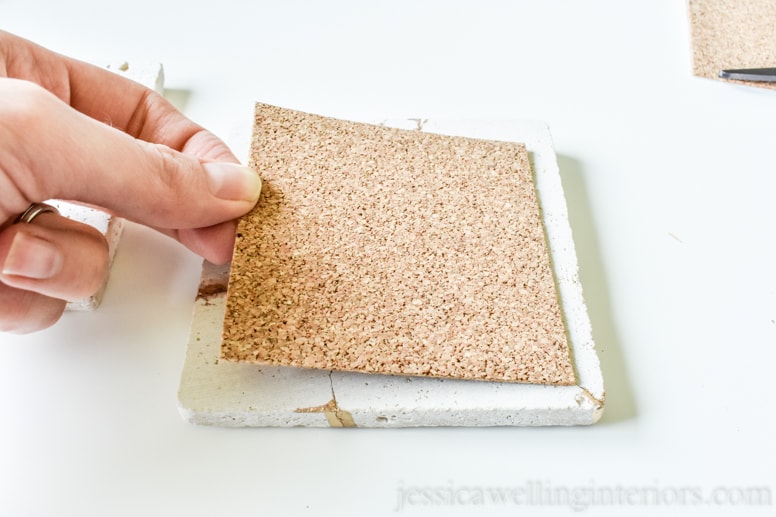 image of someone putting cork back on kintsugi tile coaster