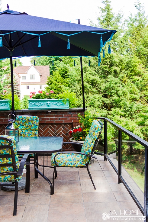 outdoor dining set with shade umbrella with blue tassels