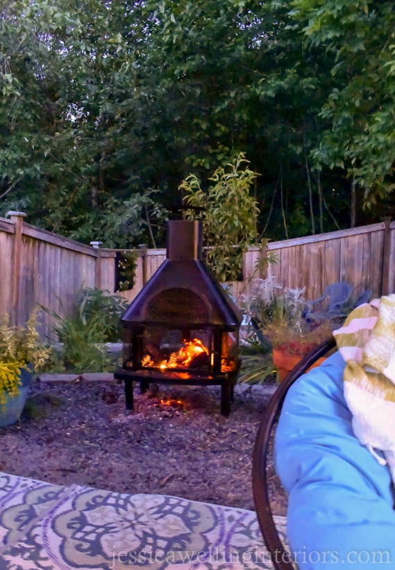 outdoor fireplace with papasan chair in the foreground