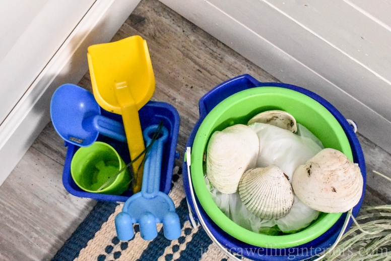 sand toys in the entryway of a beach house bunk room
