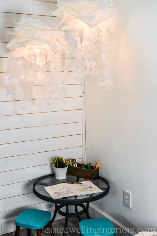 jellyfish lights glowing against a white background over a kids table with art supplies