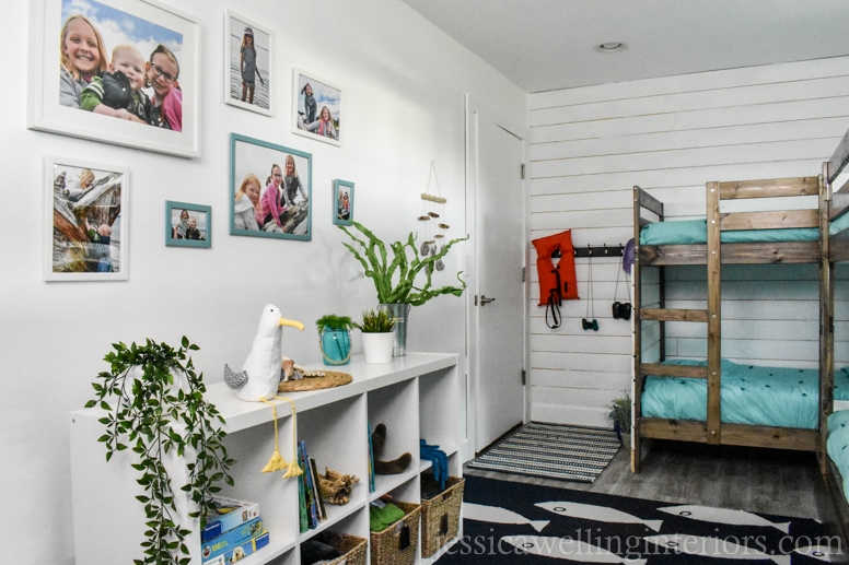 DIY beach house bunk room with photo gallery wall, IKEA Kallax bookshelf with toys and books