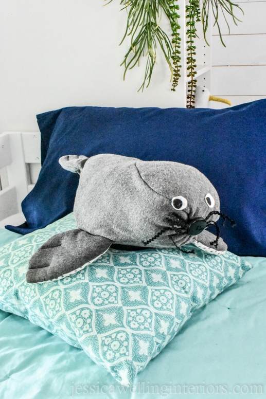 homemade stuffed seal on a bunk bed in a beach house