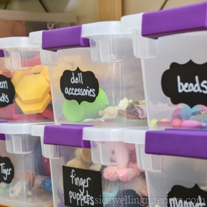 stacked containers of toys with chalkboard labels