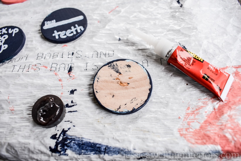 wood coin turned over to be glued to a magnet. small tube of super glue