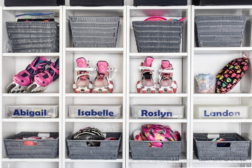 close-up of 4 Billy bookcases from Ikea lined up to make a backpack organizer. Top shelves hold rollerskates, bike helmets, and storage baskets