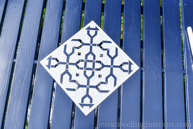 patio tabletop spray painted navy blue with stencil for fpainting furniture lined up in the center ready to be painted