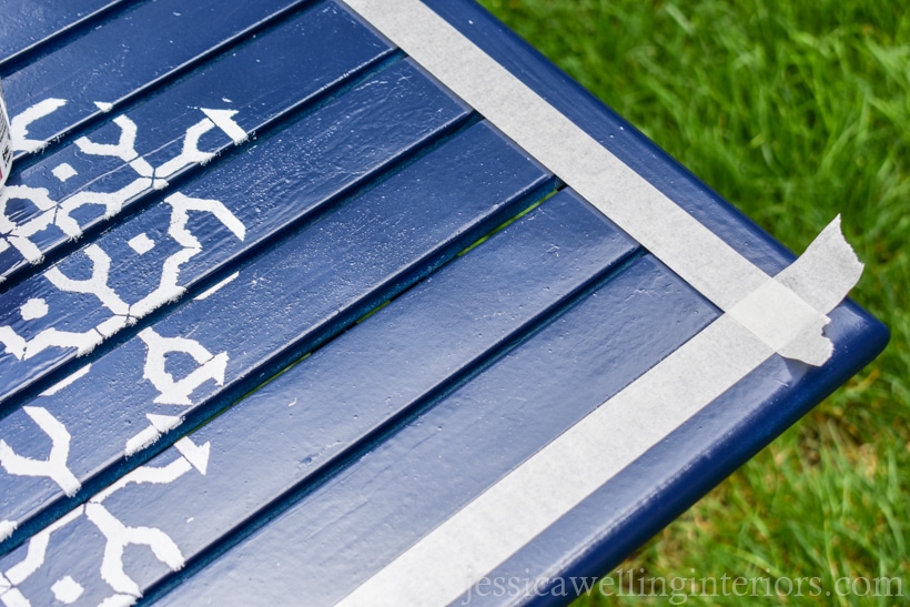 navy spray painted patio table with masking taped edges