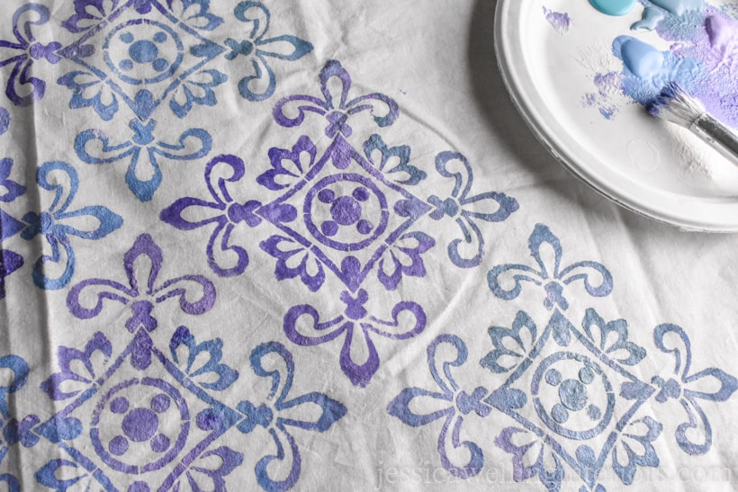 white fabric painted with ombre purple and blue paint in Moroccan tile stencil pattern