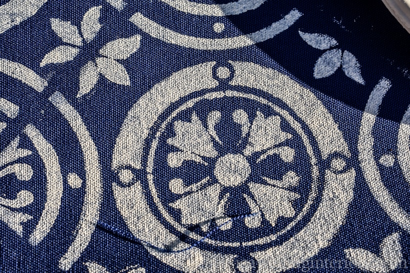 Navy blue outdoor fabric painted with Moroccan tile stencil pattern in white