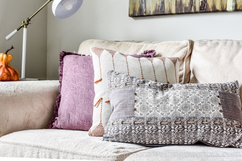 plum purple and neutral Fall living room decor with boho pillows