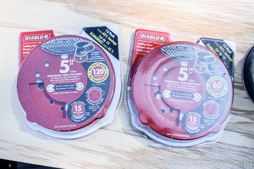 Diablo red sandpaper discs in their packages sitting on plywood- 120 grit and 60 grit