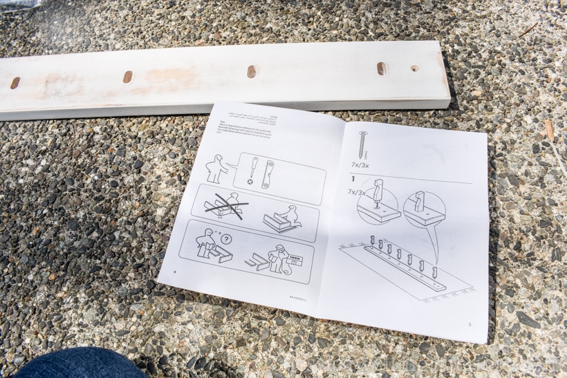 IKEA KUBBIS coat hooks rack laying on cement patio, with assembly instructions out