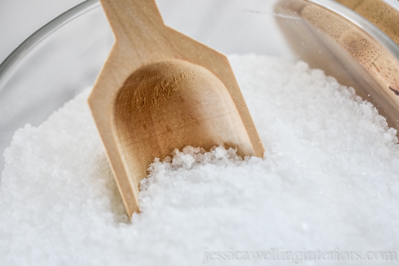 close-up of homemade bath salts with a wood scoop