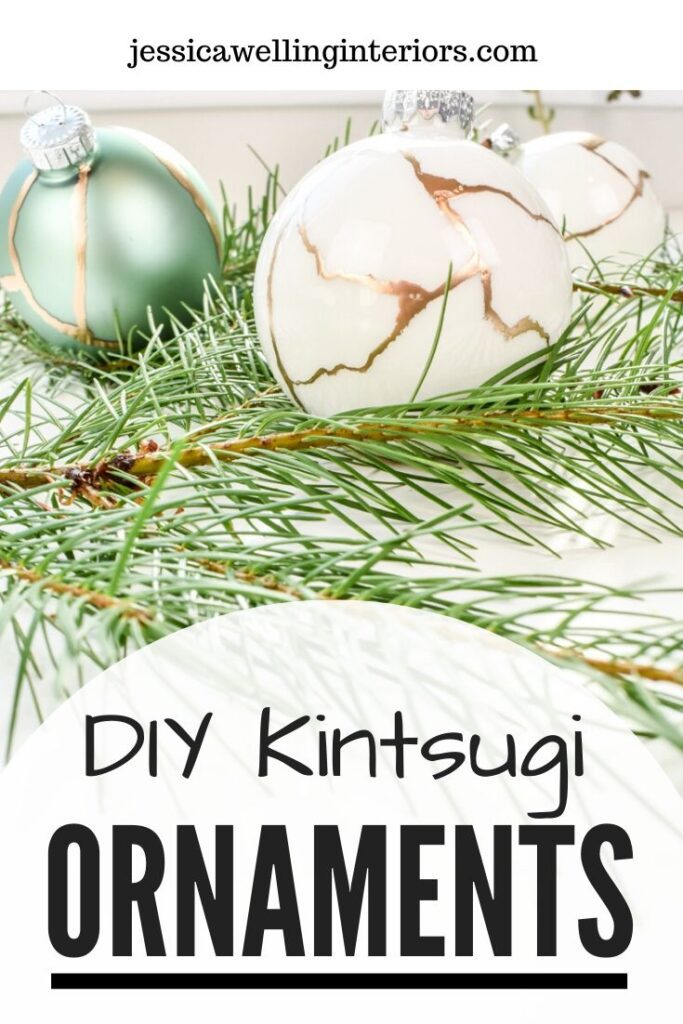 DIY Kintsugi Ornaments: white and aqua colored glass ball ornaments painted with gold leaf paint to look like kintsugi on fir branches