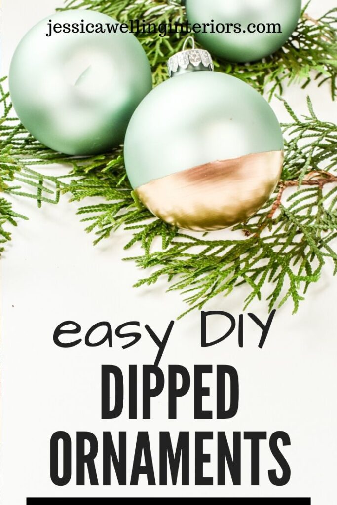 Easy DIY Dipped Ornaments: Three aqua and gold glass ball ornaments dipped with gold paint sitting on Christmas greenery