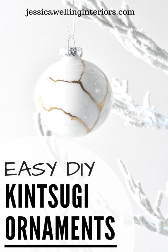 Easy DIY Kintsugi Ornaments: white glass Christmas ornament with gold lines hanging from a white tree