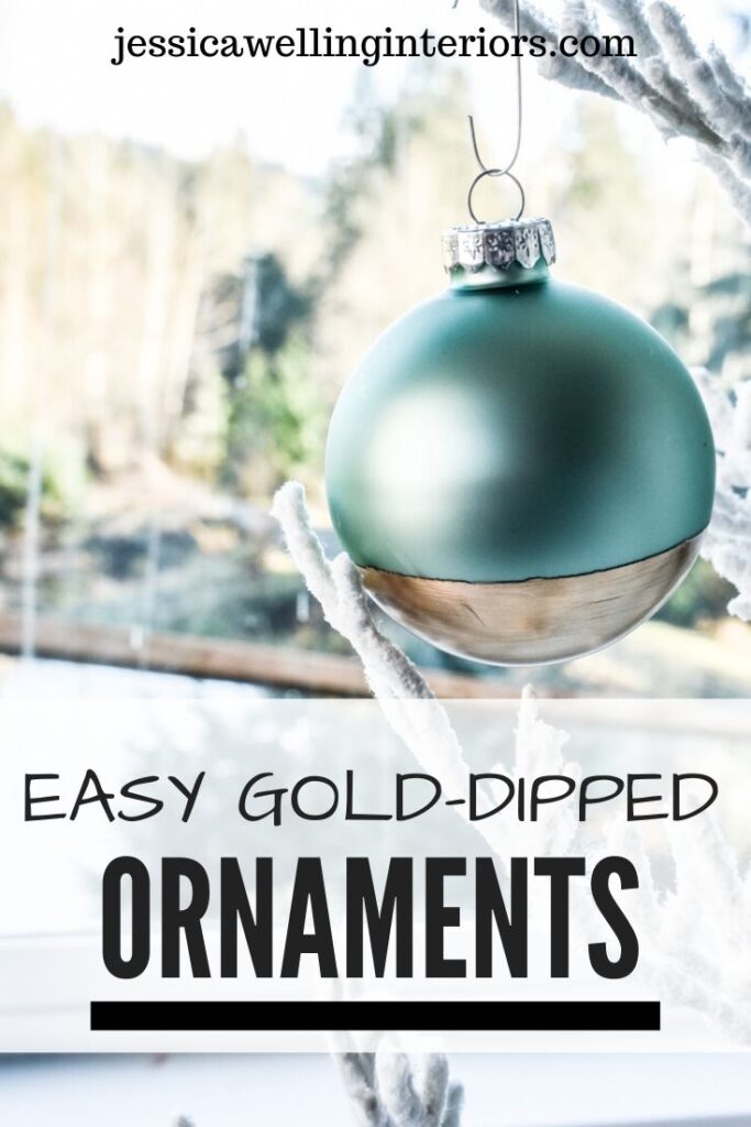 Easy Gold-Dipped Ornaments: aqua glass ball ornament dipped in gold leaf paint in front of a window