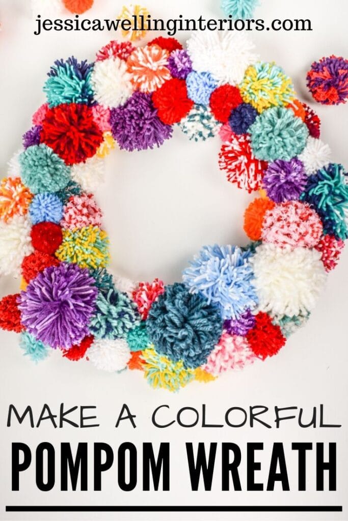 Make a Colorful Pompom Wreath!: brightly colored pom pom wreath on a white background