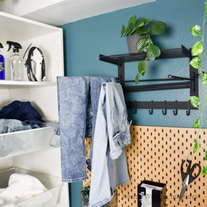 small laundry room with a wall mounted clothes drying rack