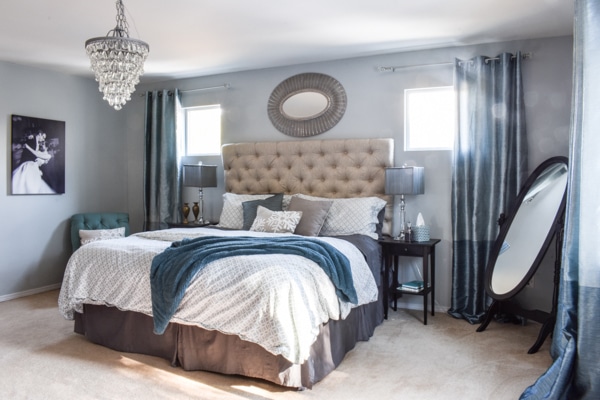 master bedroom brightened up with light paint colors and multiple mirrors to bounce natural light around the room