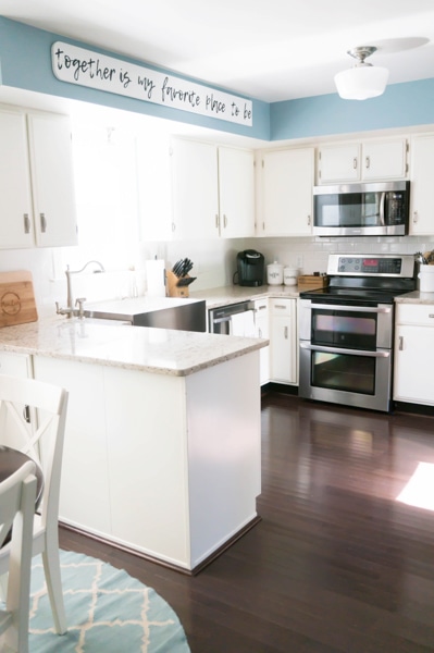 example of how to brighten a dark kitchen: dark cabinets have been painted white