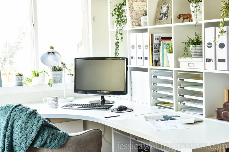 bright home office with white walls and white furniture to maximize the natural light coming into the room from the windows