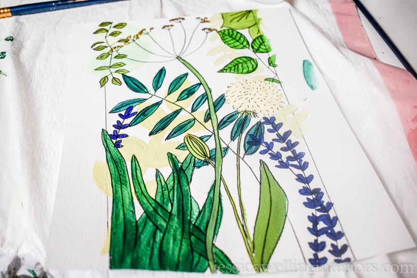 hand-painted botanical wall mural plan drawn and painted on a piece of paper with greens, yellow, and blue flowers