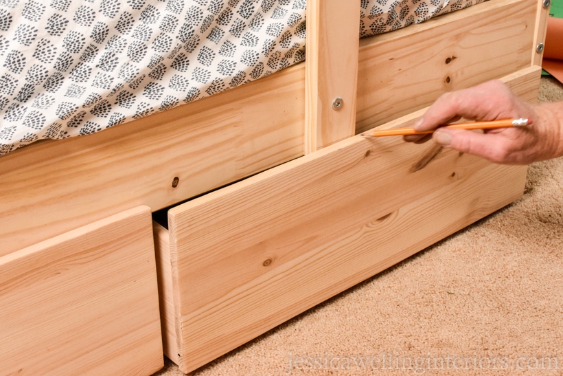 close-up of Ikea Mydal bunk bed hack with hand drawing pencil line on bottom of ladder