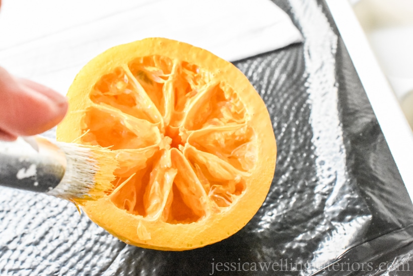 close-up of hand painting the cut surface of a lemon to print it on a flour sack dish cloth