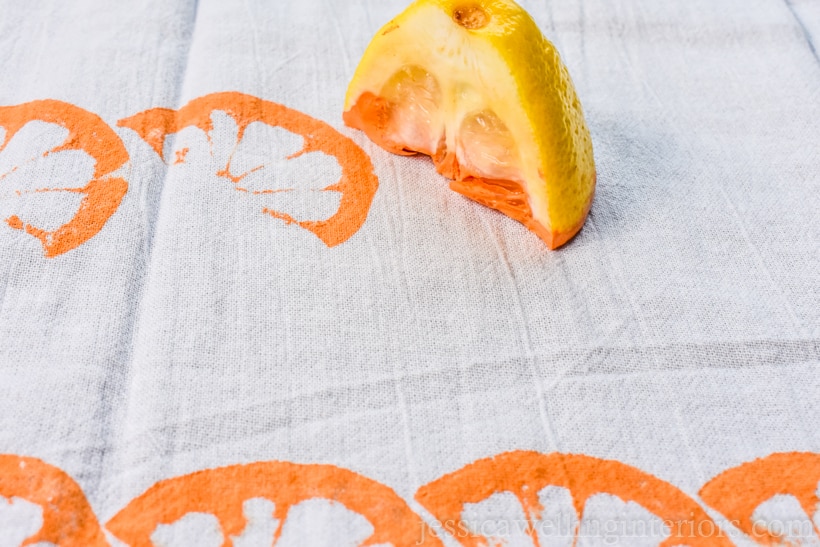 fabric paint flour sack towel being stamped with a lemon