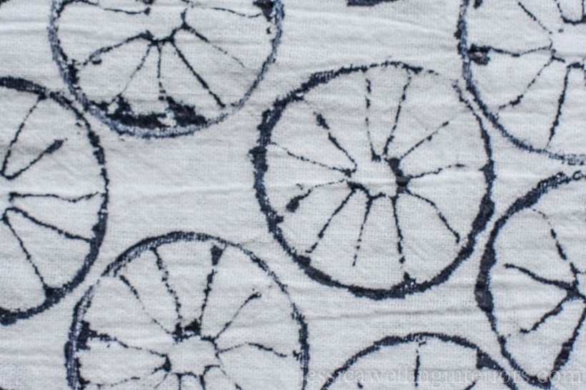 close-up of white tea towel stamped with a lime in navy paint