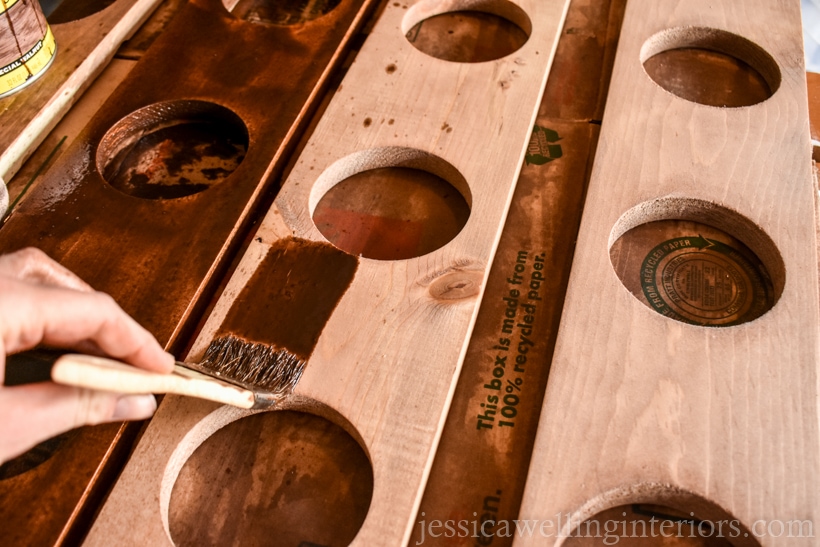 brush applying 2nd coat of wood stain to artificial vertical garden planter