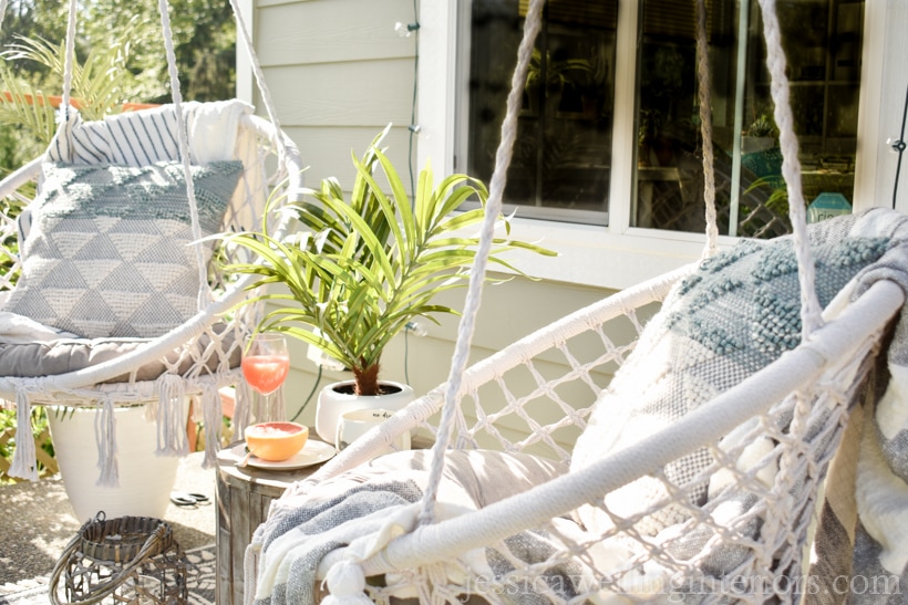 close-up of macrame swings on a porch with cushions and outdoor pillows