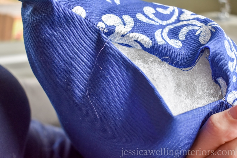 close-up of the end of an outdoor lumbar pillow with the stuffing showing before being stitched closed