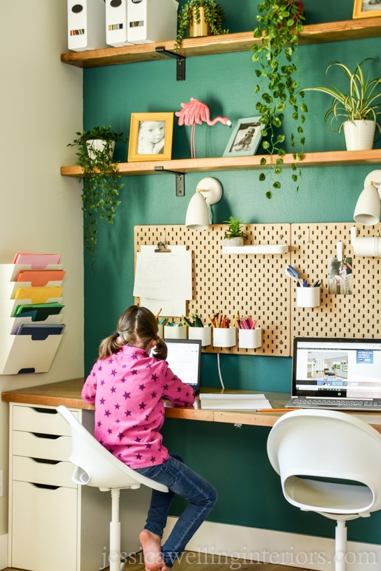 girl working on a laptop computer at a school desk for home 