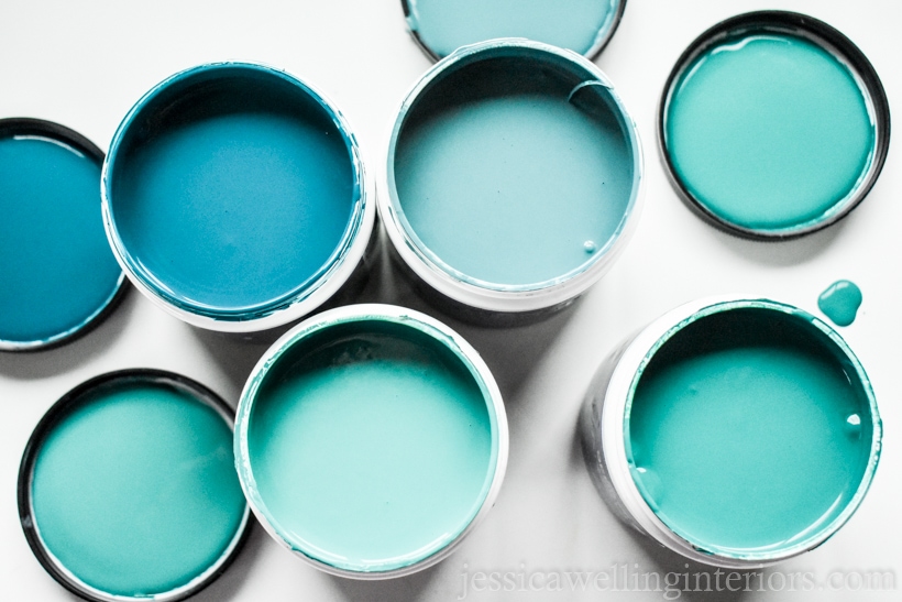 close-up of blue and green paint sample pots for a homeschool room accent wall