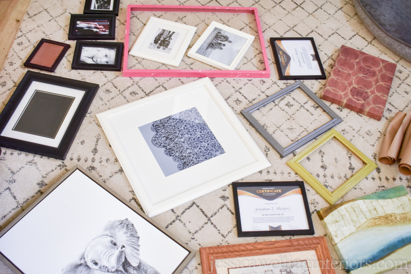 a variety of old picture frames laid out on the floor