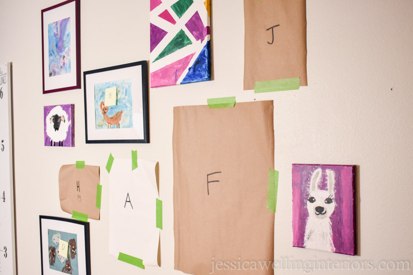 partially completed kids art display wall with some templates and some pieces of art already mounted to the wall