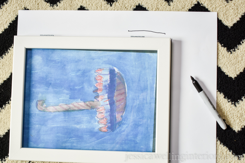 white frame with a child's watercolor painting being traced